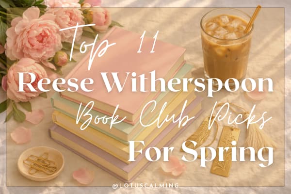 Flat lay of a stack of pastel-covered books, surrounded by pink peonies, a glass of iced coffee, and gold bookmarks